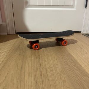Youth Skateboard with Black Deck and Red Wheels